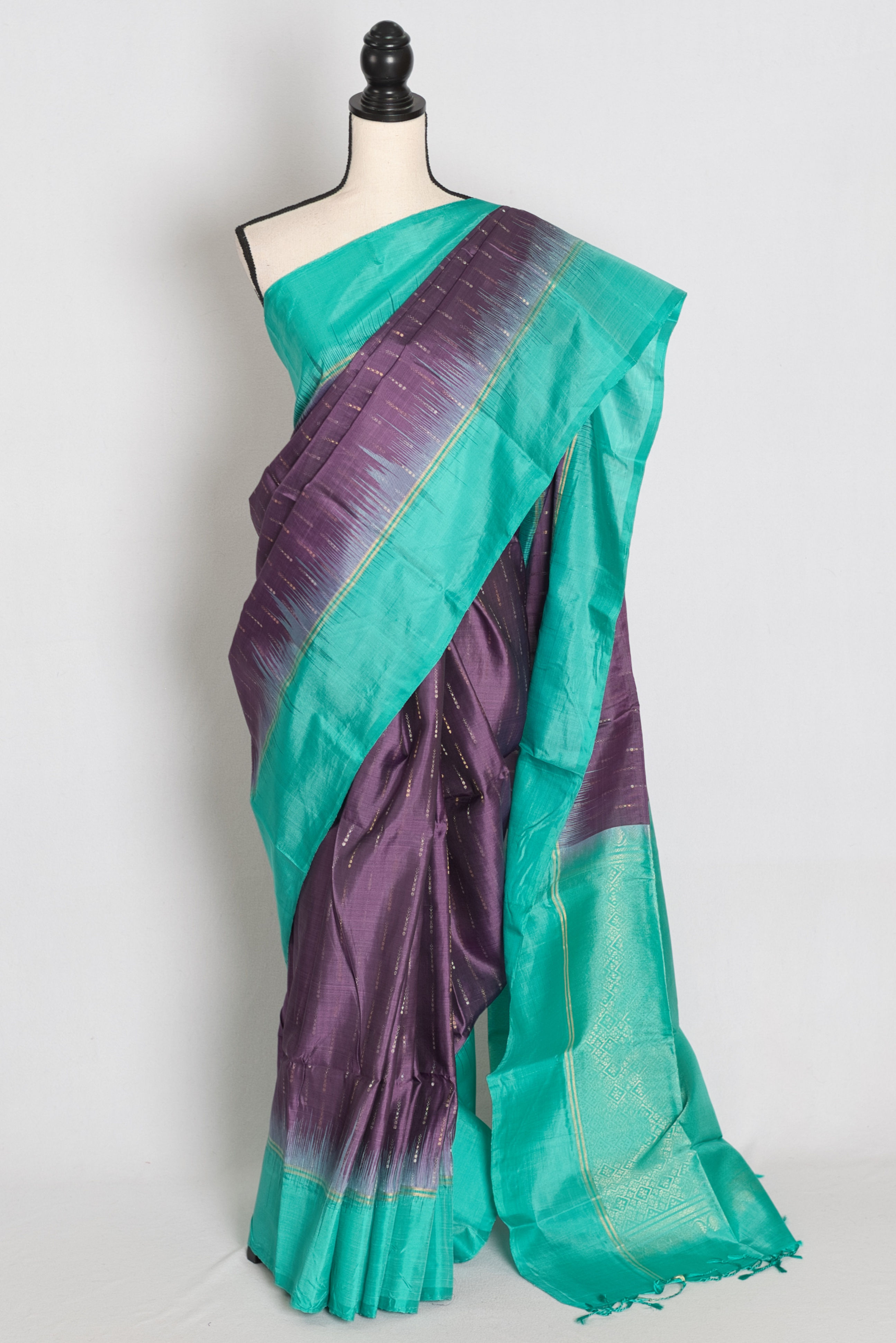 Violet lightweight Kanjivaram silk saree featuring fine gold zari dashes, a solid sea green border, sea green brocade pallu.