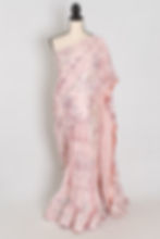 Baby pink designer soft net sequin partywear saree on a mannequin showing floral sequin embroidery.
