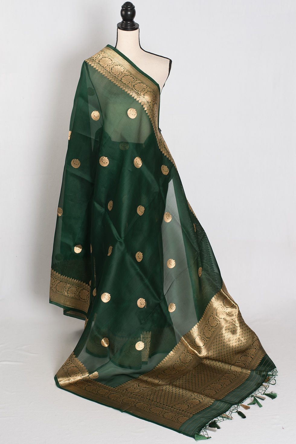 bottle green and gold kora organza banarasi saree featuring hand woven chand sitara motifs on a mannequin drape.