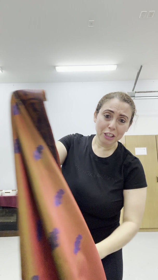Video of the orange and green shot silk handwoven Baluchari saree draped on a mannequin.