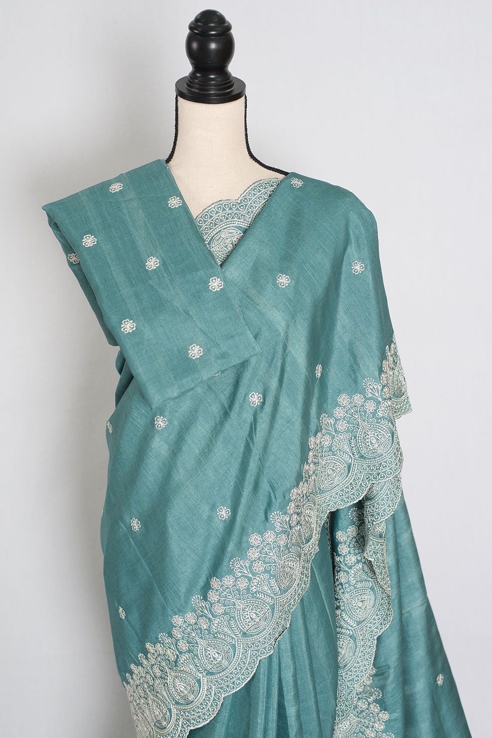 Thumbnail: Pastel blue semi tussar silk saree on a mannequin displaying its soft fluid drape and intricate white thread embroidery.