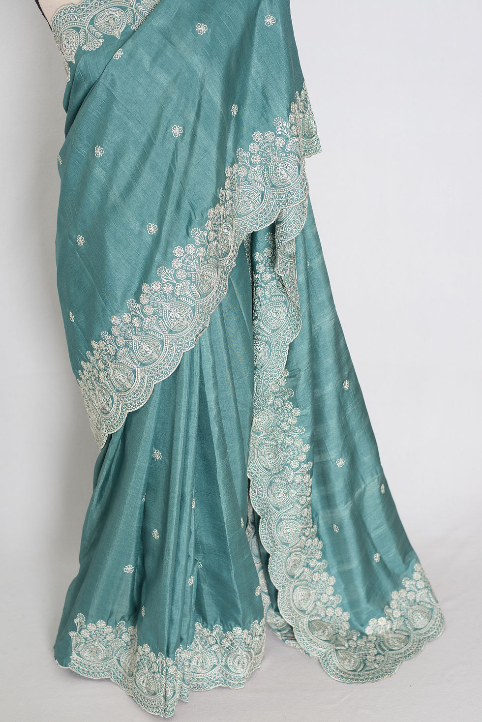 Thumbnail: Pastel blue semi tussar silk saree on a mannequin displaying its soft fluid drape and intricate white thread embroidery.