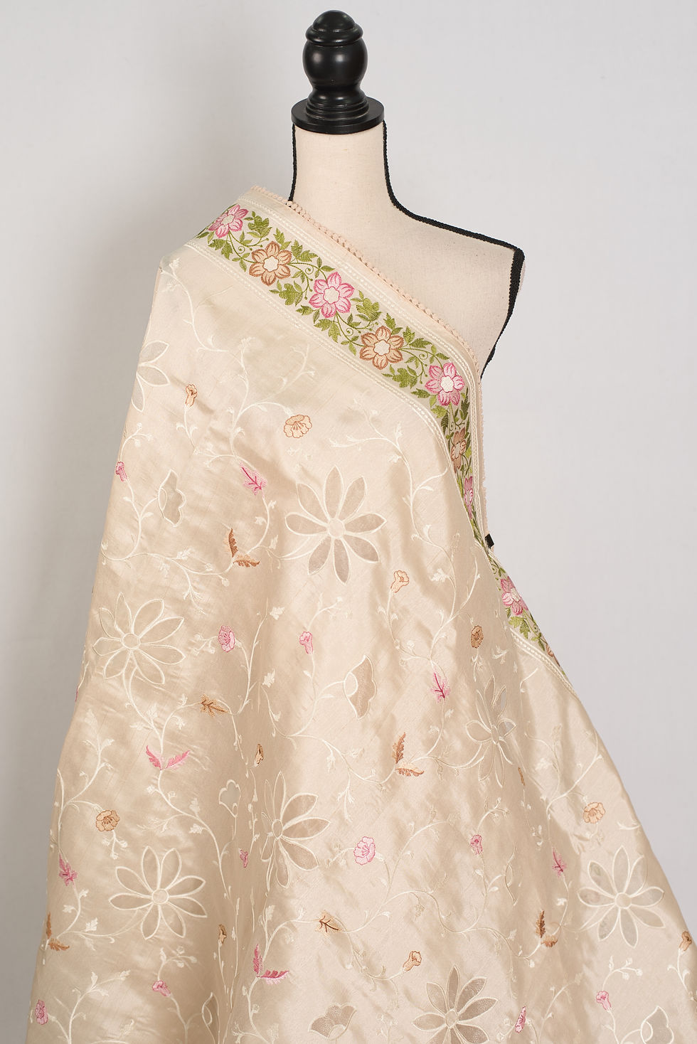 Thumbnail: Shreya cream semi Tussar silk saree with multi-color floral embroidery and cut work on a mannequin.
