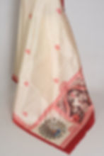 Cream and red semi silk Durga Puja saree on a mannequin featuring a printed red border with Goddess Durga's face in the pallu