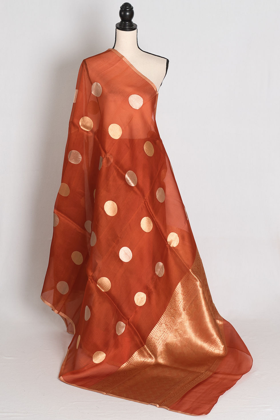 Rust brown Kora organza Banarasi saree featuring large gold zari polka dot woven motifs, slender gold border, zari pallu.