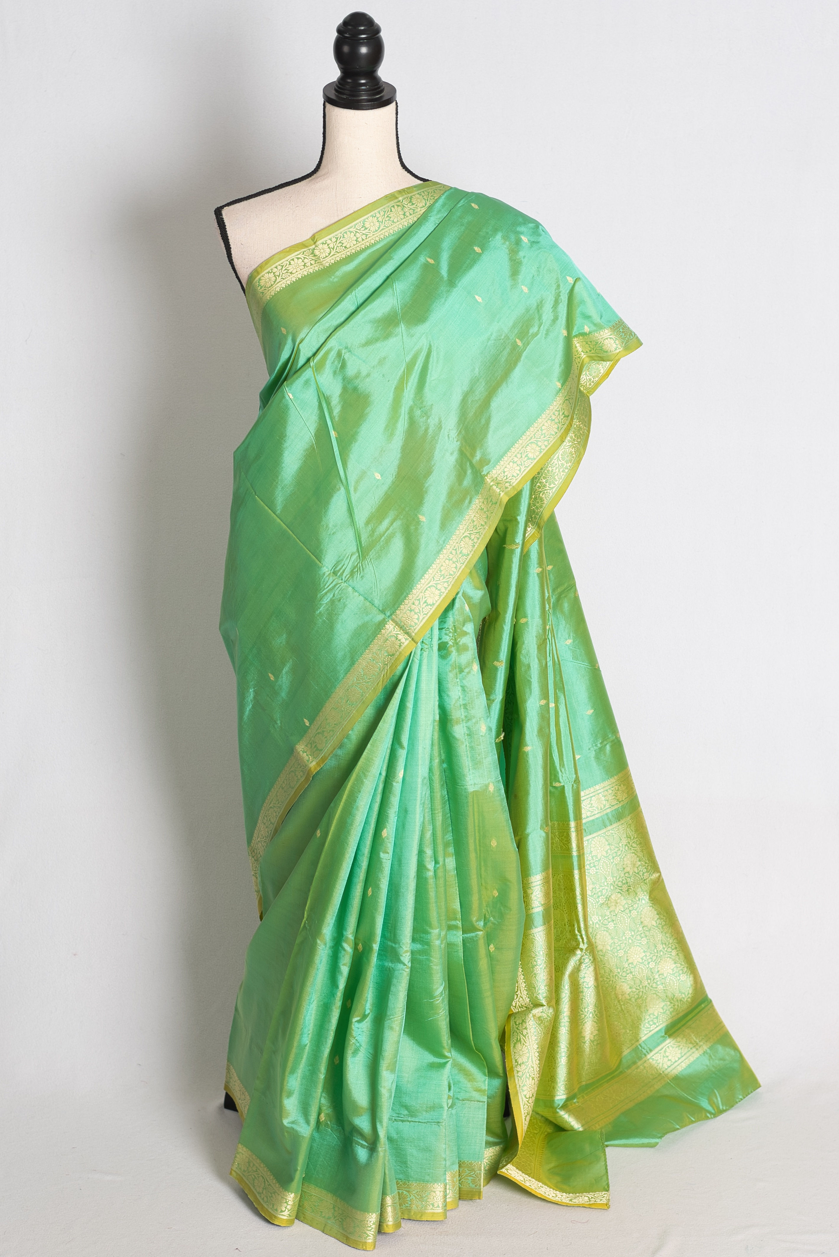Green and Gold Lightweight Katan Banarasi Silk Saree draped elegantly on a mannequin.