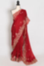 Front view of the bright red tissue zardosi embroidery saree draped on a mannequin.