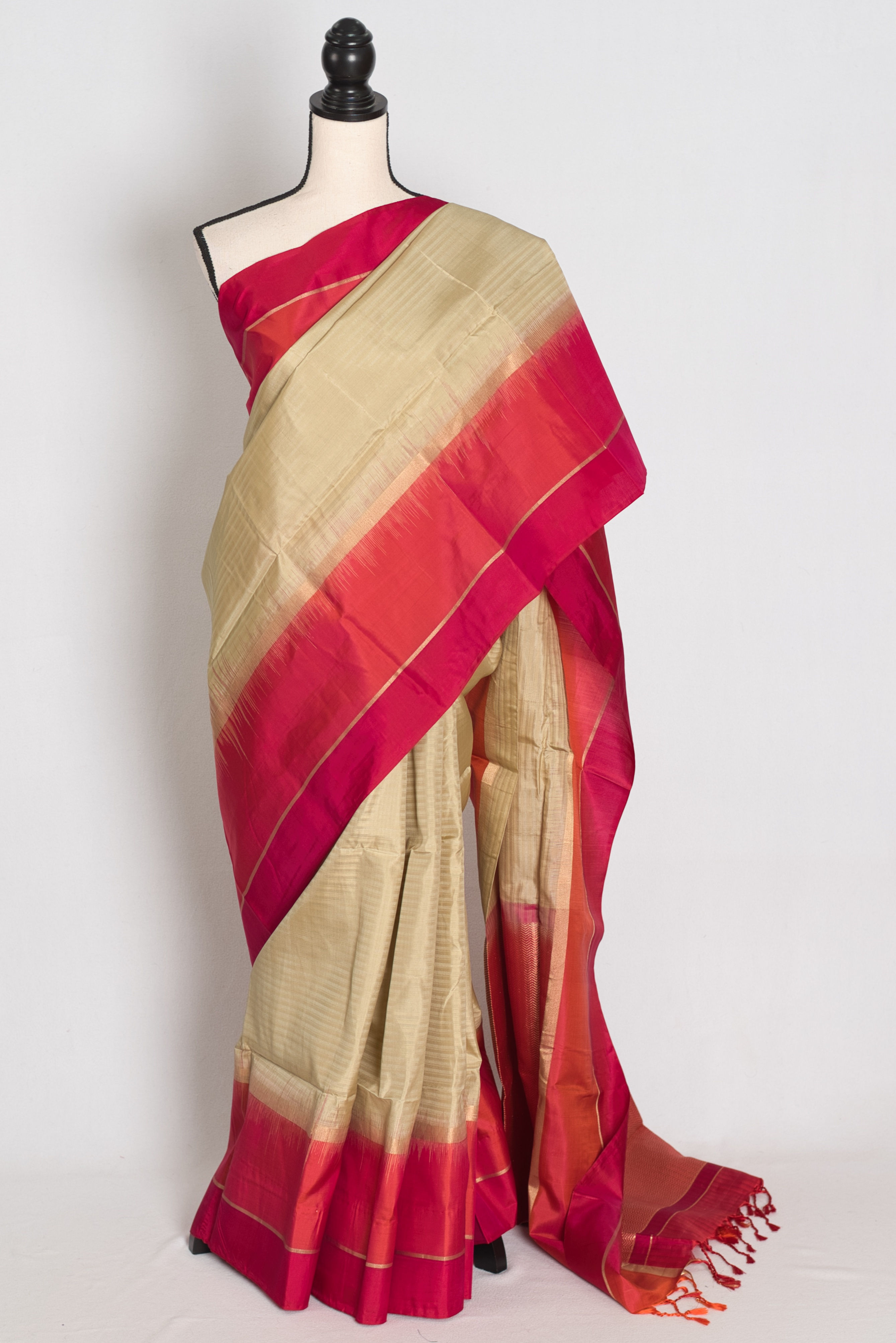 Clay brown lightweight Kanjivaram silk saree featuring a wide orange and red border, gold zari pinstripes, brocade pallu.