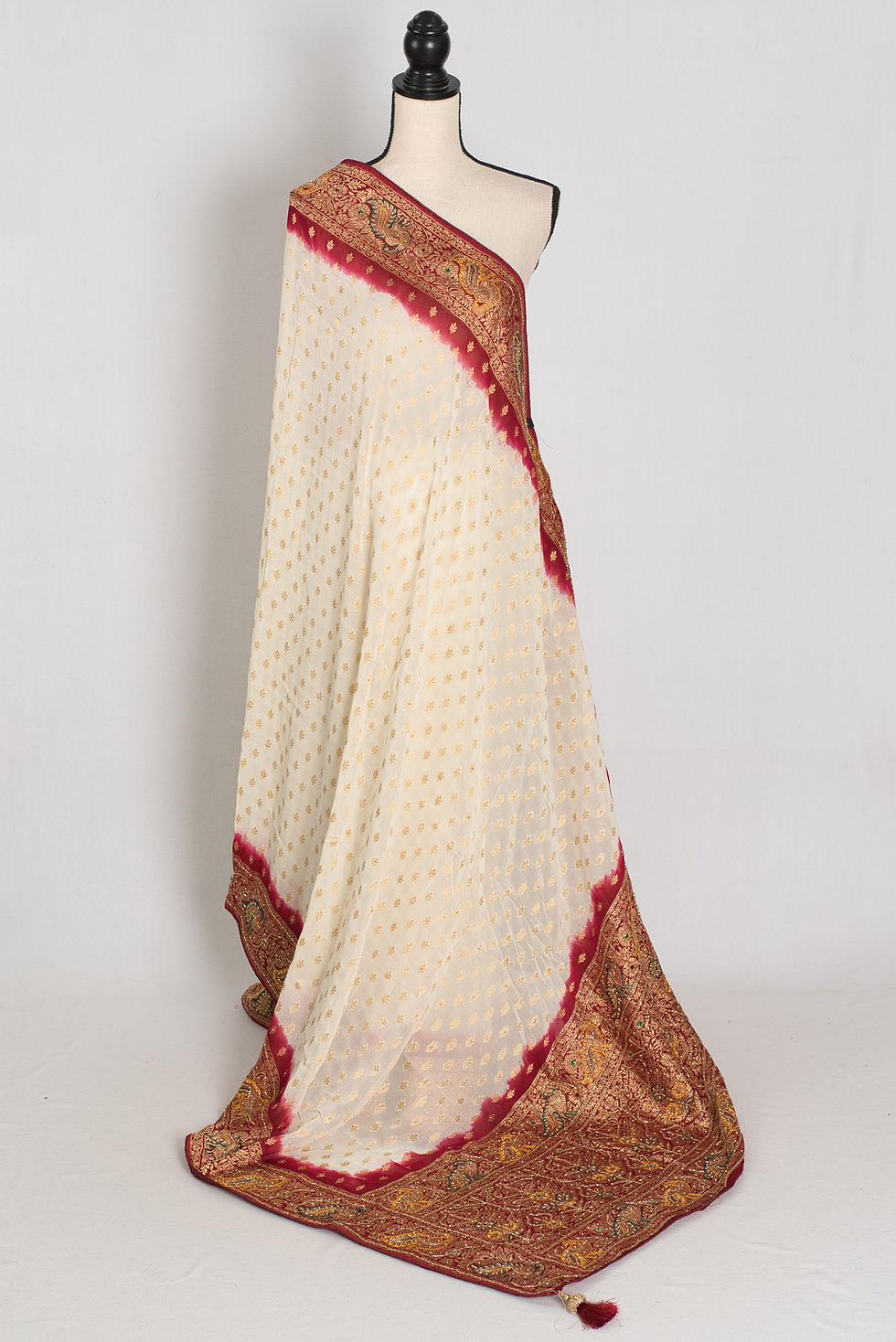 Front full-length view of the cream and maroon crepe georgette Banarasi saree draped on a mannequin.