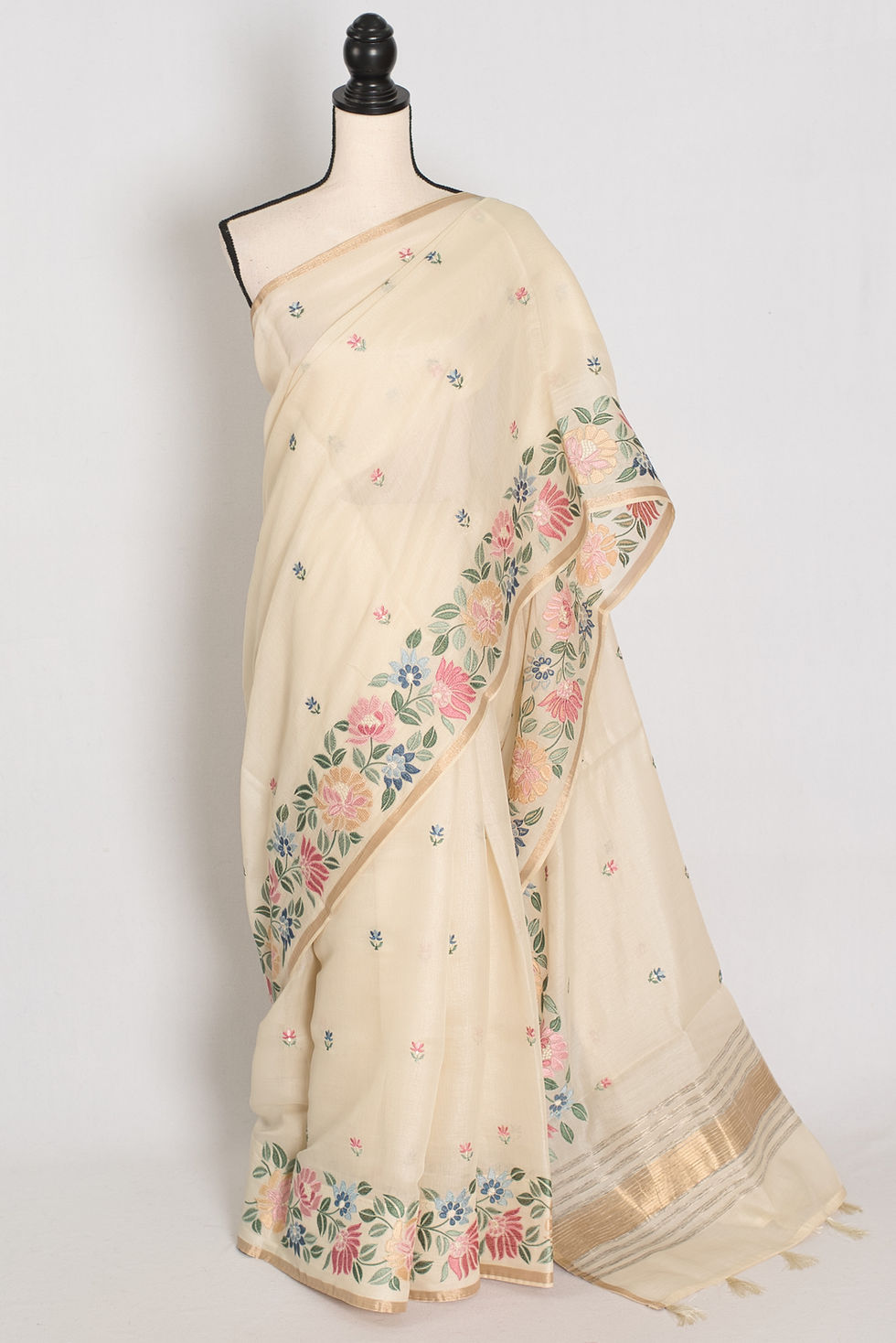 Elegant beige blended cotton saree featuring dense multi-color floral machine embroidery on the borders.