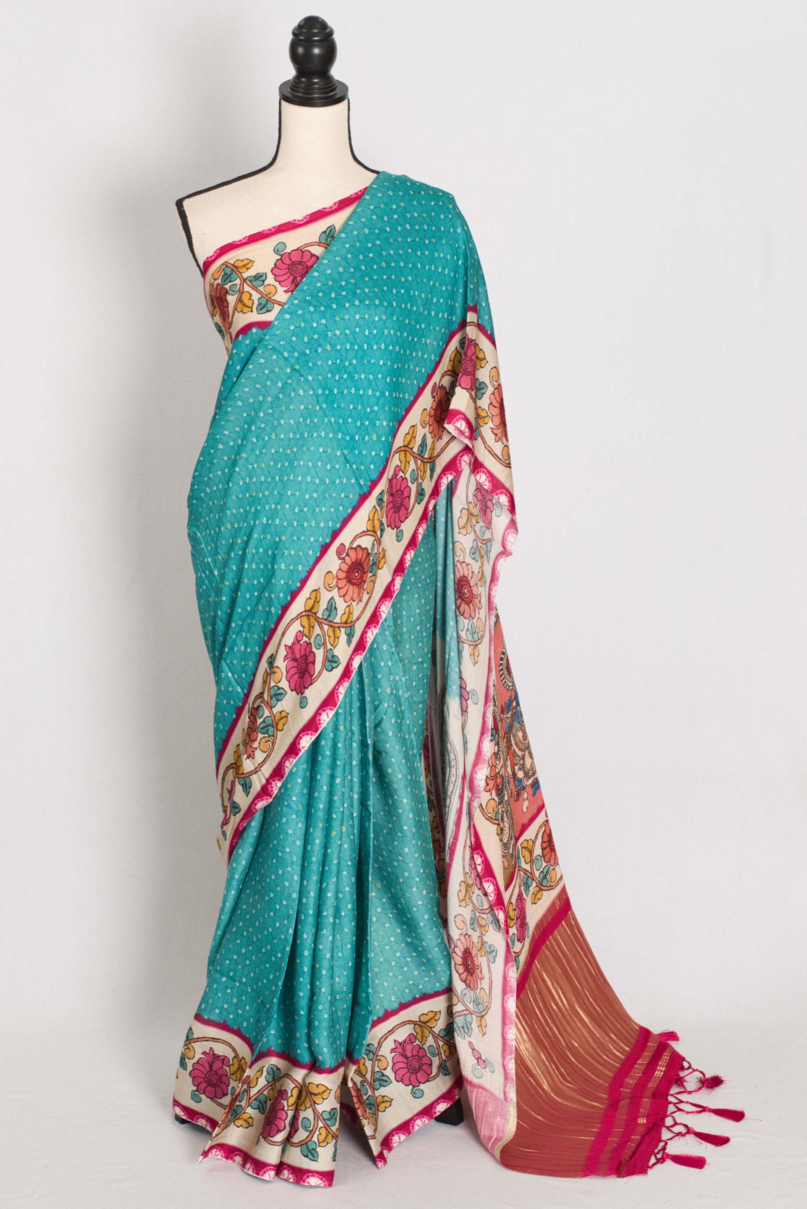 Vibrant turquoise blue modal silk saree featuring a digital bandhani print body and a multi-color kalamkari printed border.