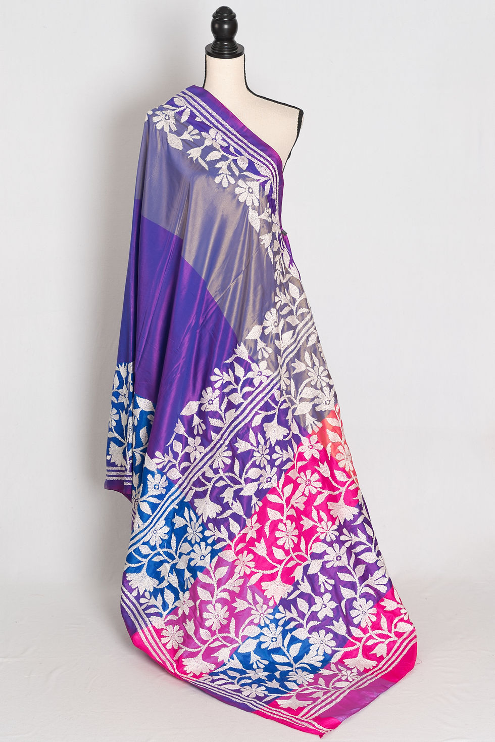 Purple, blue, and pink semi silk saree featuring off-white hand-embroidered Kantha floral vine borders from Bolpur.