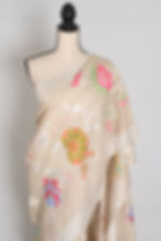 Thumbnail: Warm beige Tussar Georgette Banarasi saree with large pink, blue, and orange Minakari floral motifs and silver border.