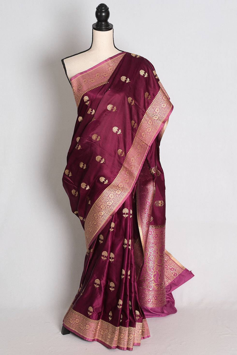 Deep Wine and Pink Semi Mashru Banarasi Silk Saree draped on mannequin with golden woven border and pallu.