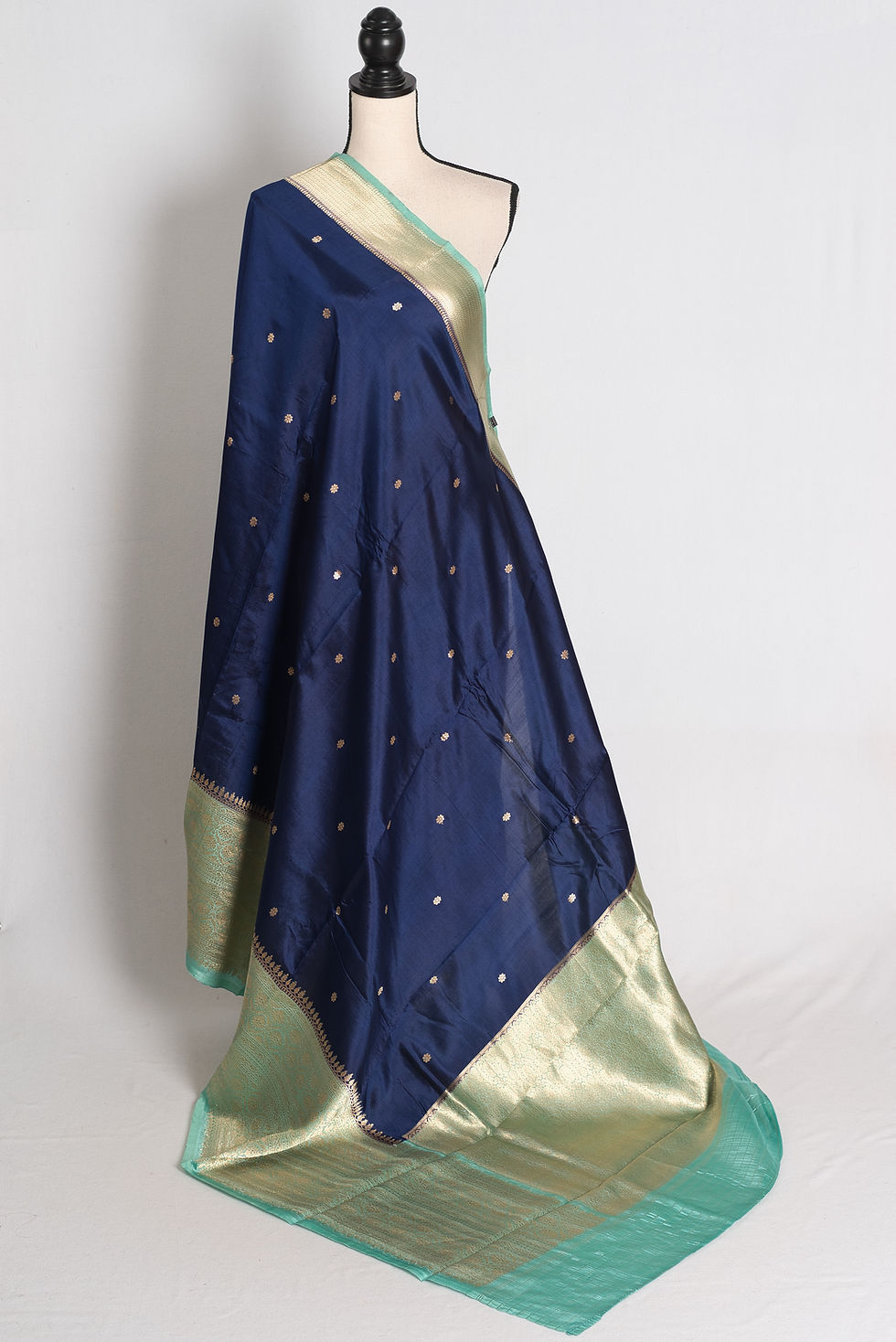 Midnight Blue and Sea Green Mango Silk Banarasi Saree draped elegantly on a mannequin showcasing its wide brocade border.