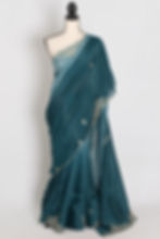 Front full-length view of the teal green shaded soft organza partywear saree draped on a mannequin.