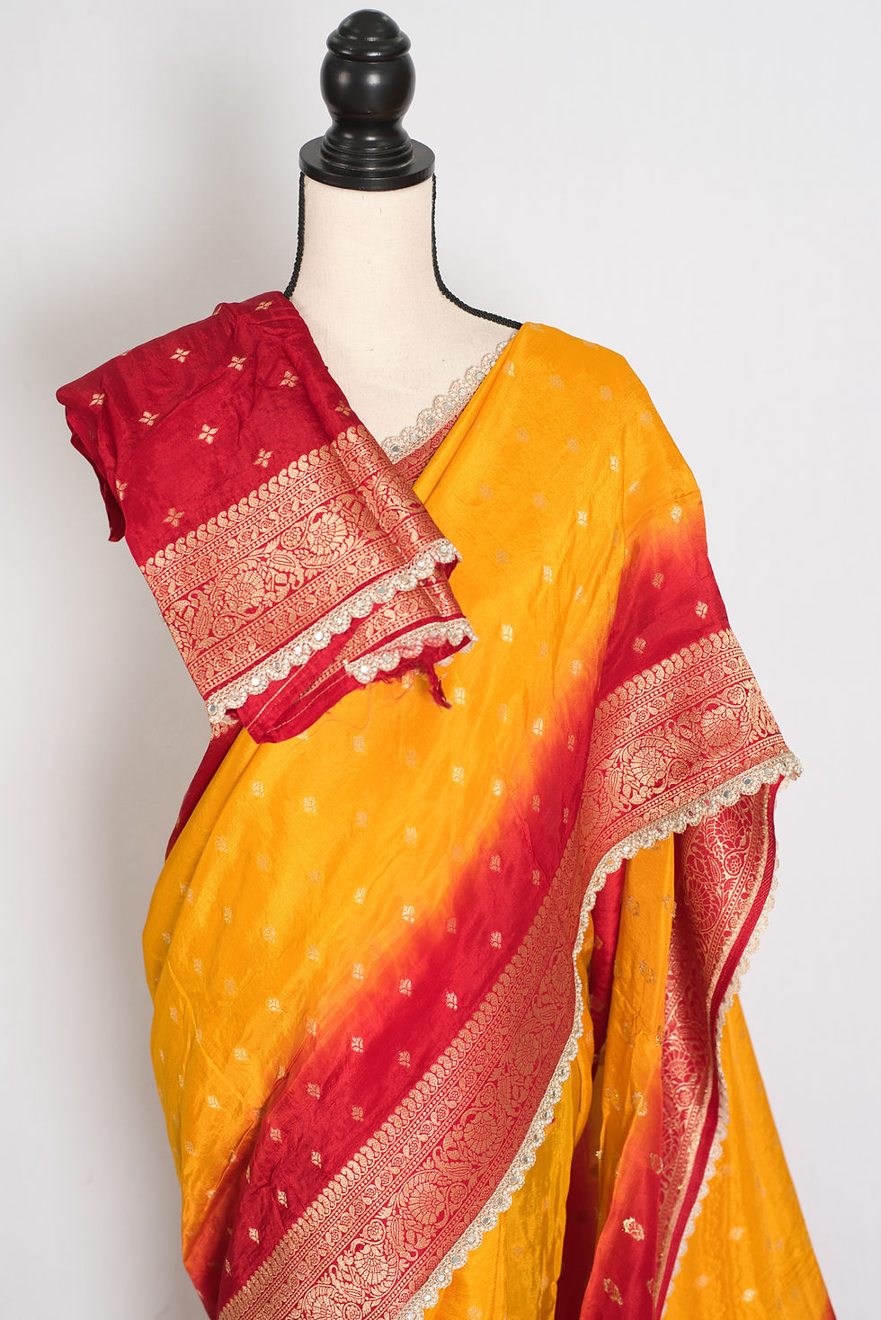 Front full-length view of the yellow and red Dola silk Banarasi saree draped on a mannequin.
