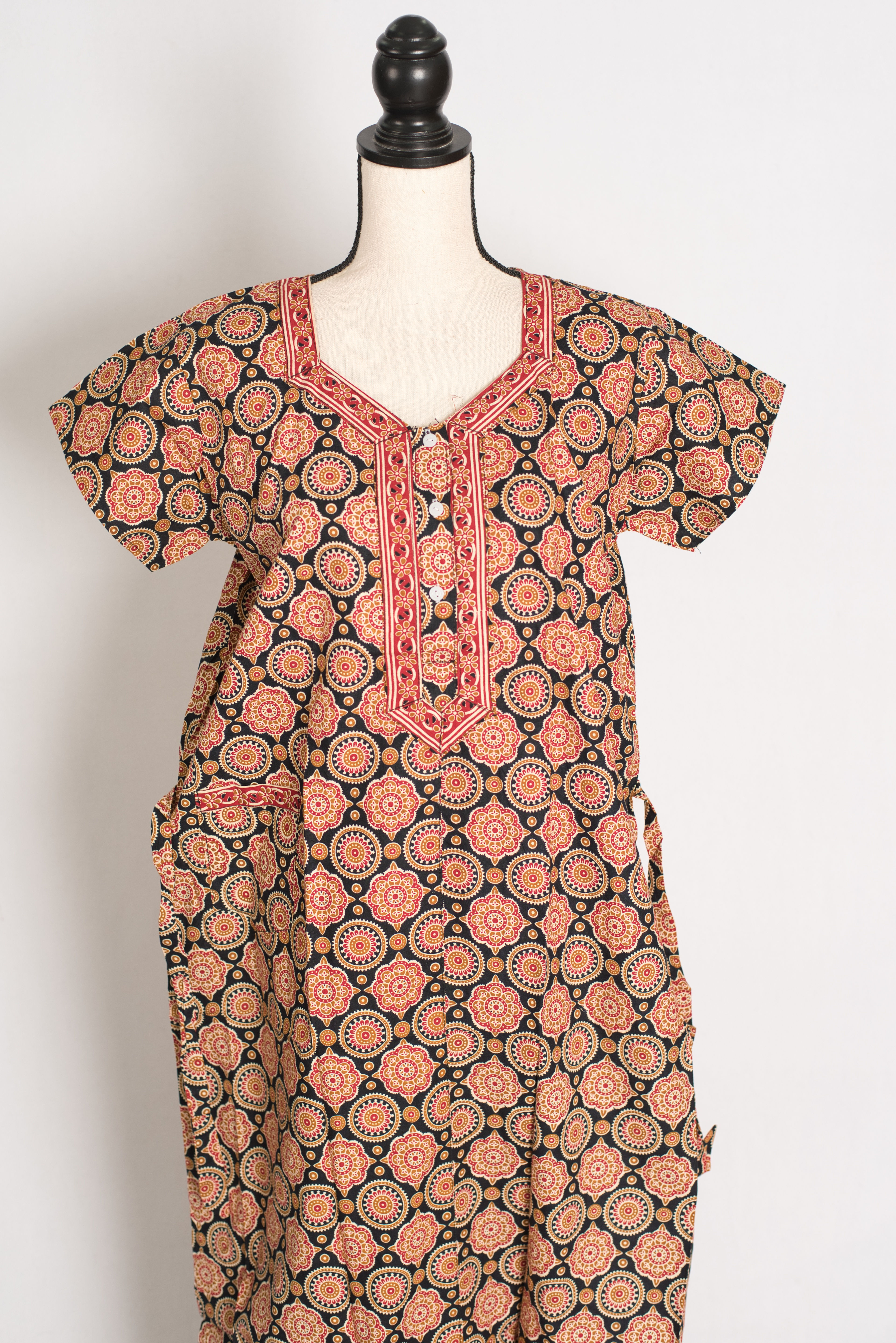 Close-up detail of the front-opening neckline and intricate Kalamkari print on a black 100% cotton women's nightgown.