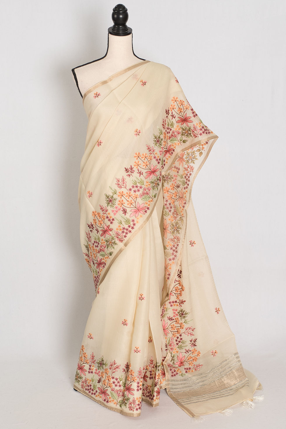 Elegant beige blended cotton saree featuring intricate multi-color thread machine embroidery on the body and border.