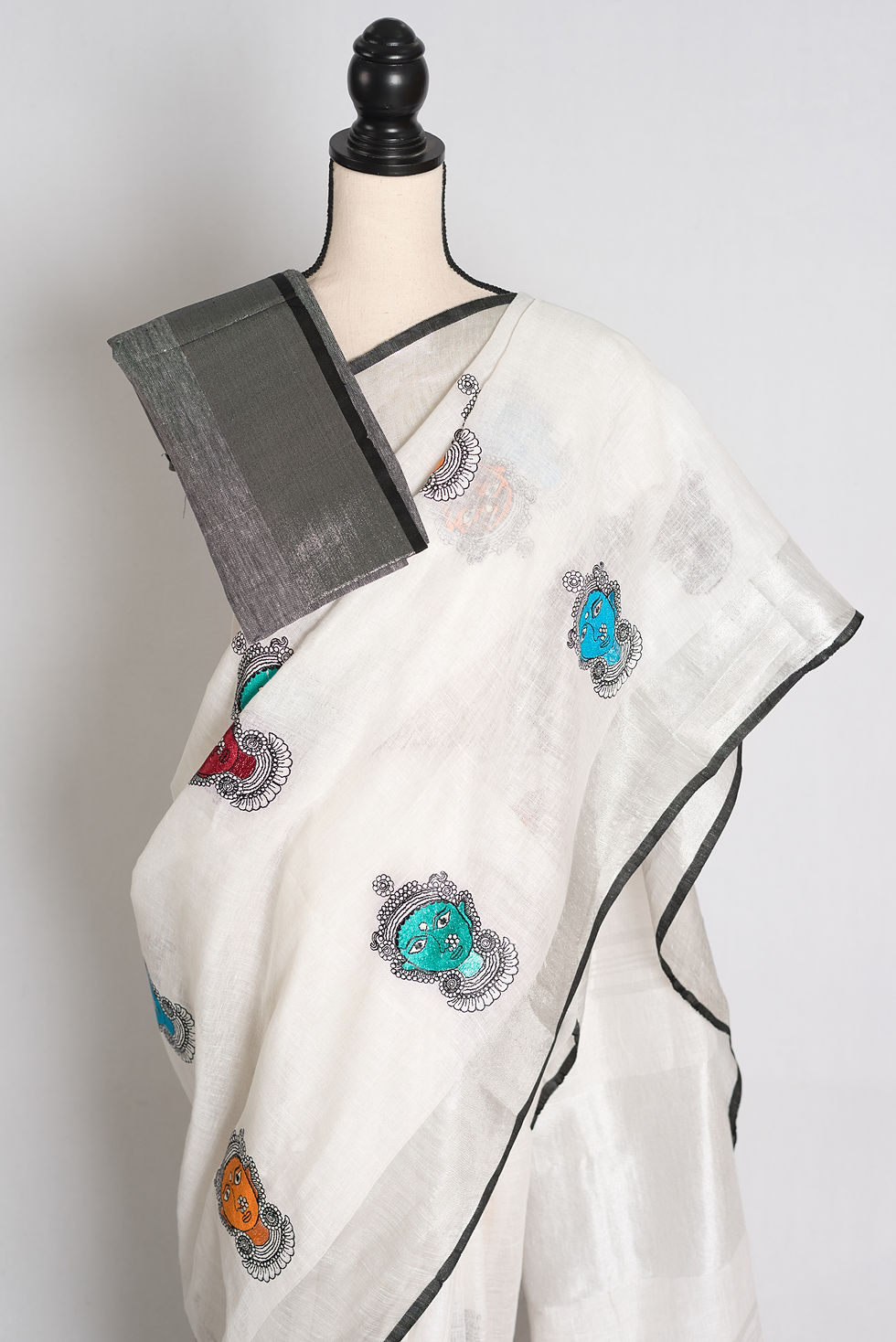 Thumbnail: White pure linen saree with colorful Durga face embroidery front drape view.