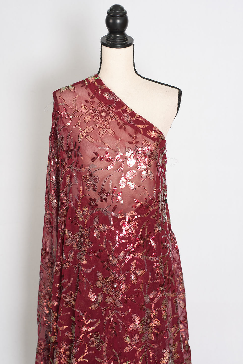 Thumbnail: Brownish maroon partywear sequin saree draped on a mannequin showcasing Bollywood-style floral sequin embroidery.