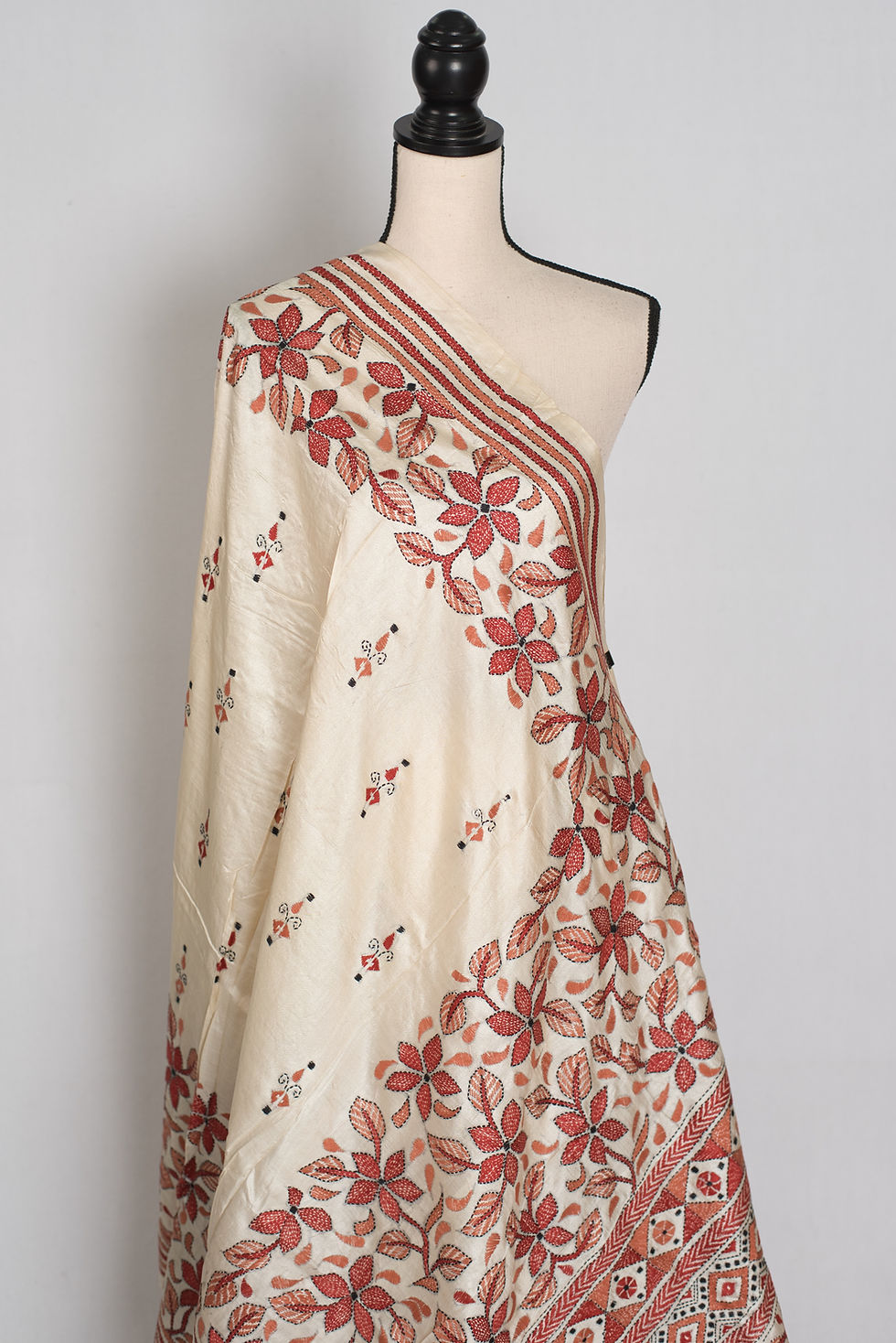 Thumbnail: Cream pure Bangalore silk saree with rust brown hand-embroidered Kantha stitch floral vines draped on a mannequin.