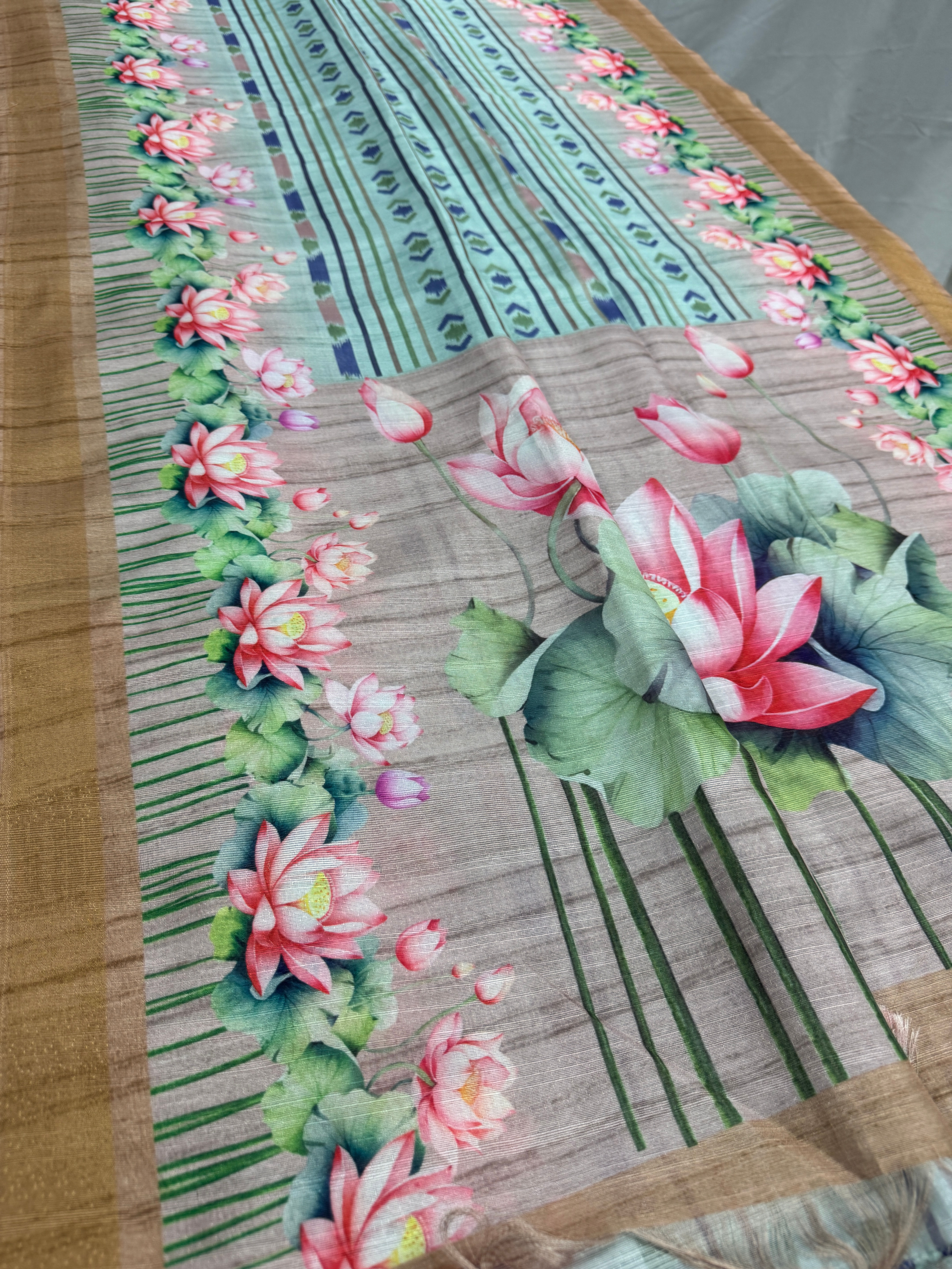 Soma collection: Sea green ikkat print semi tussar saree with pink lotus motifs and brown border, shipped from New Jersey.