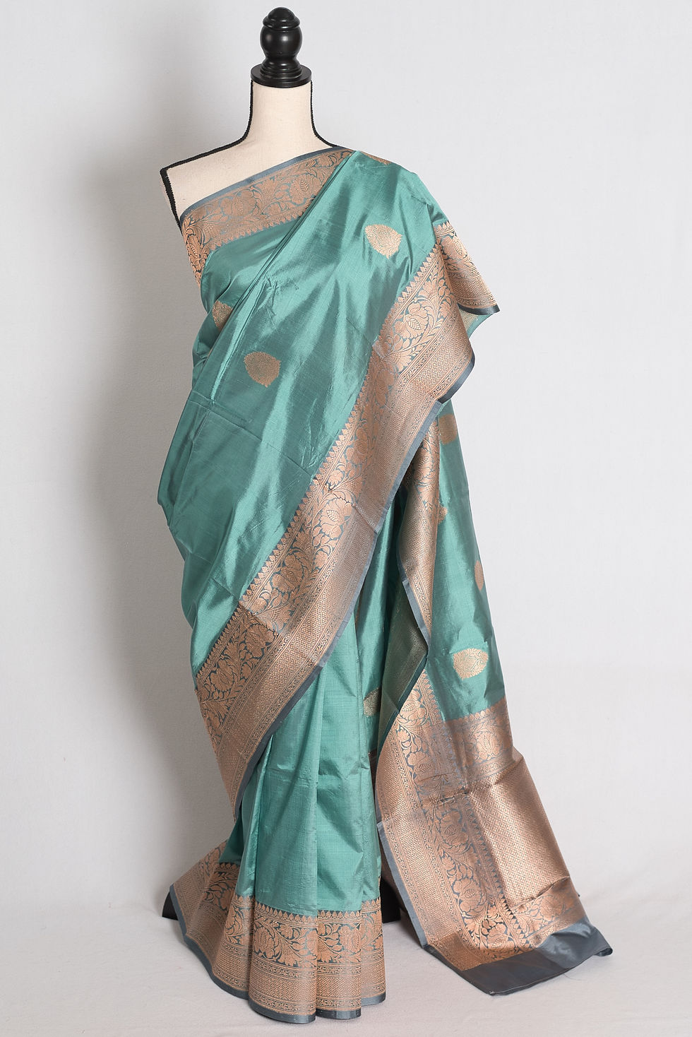 Pastel Green and Grey Banarasi Silk Saree draped elegantly on a mannequin showcasing its contrasting grey border.