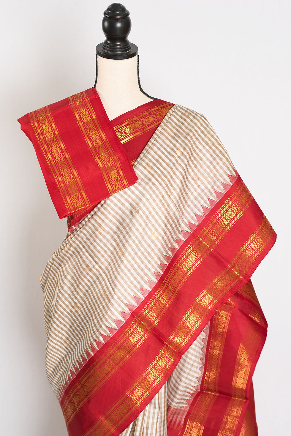 Thumbnail: Mira white and brown micro-check Gadwal silk saree with a rich red and gold zari border.