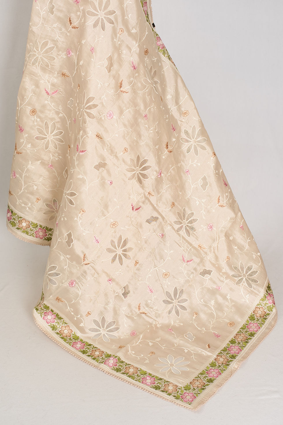 Thumbnail: Shreya cream semi Tussar silk saree with multi-color floral embroidery and cut work on a mannequin.