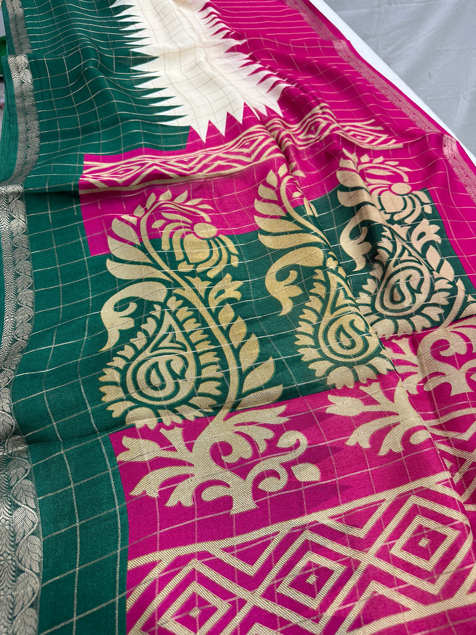 Thumbnail: Pink semi chiffon saree featuring a green temple border and subtle self-checks pattern.