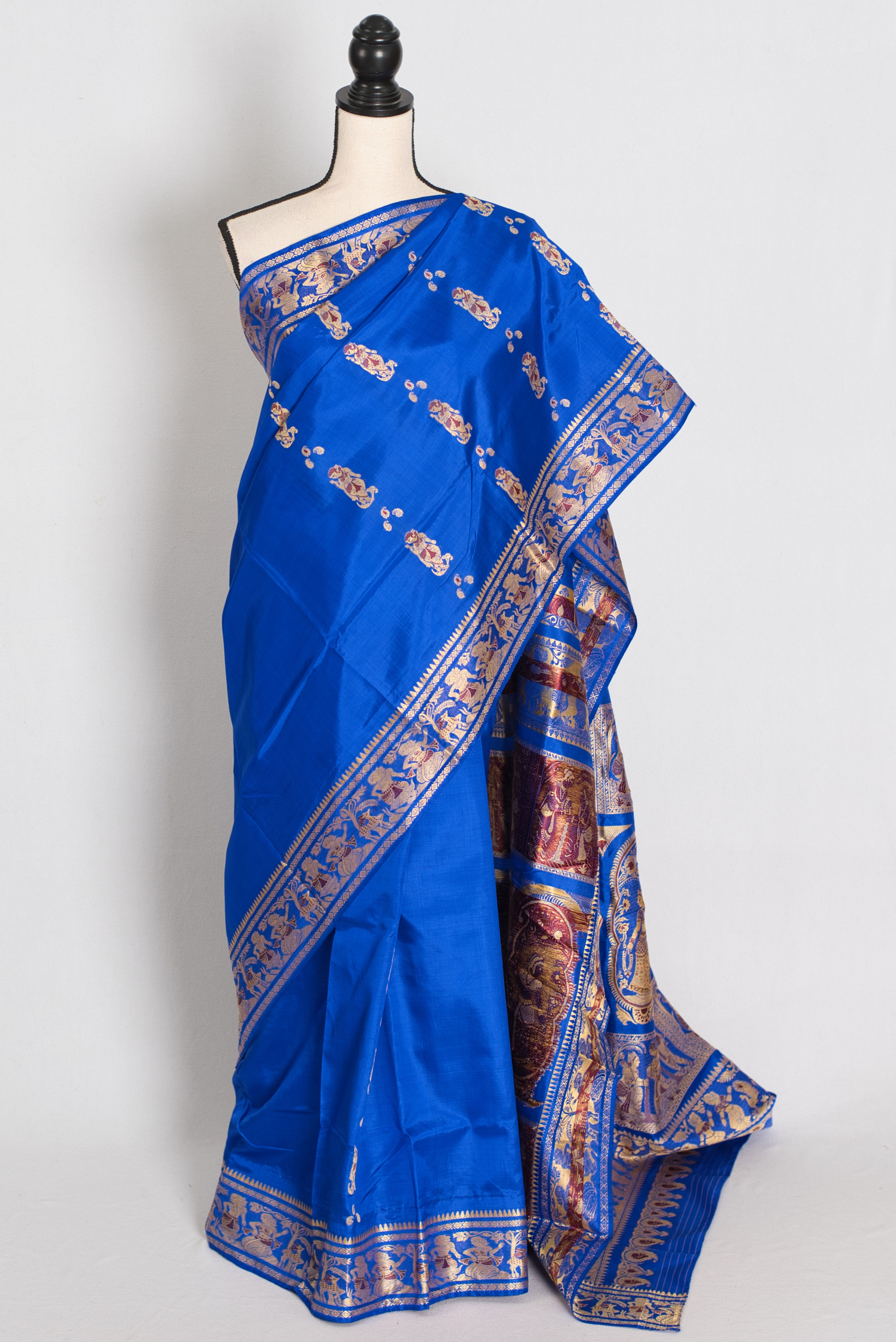 Front full-length view of the vibrant royal blue and gold handwoven Swarnachari pure silk saree on a mannequin.