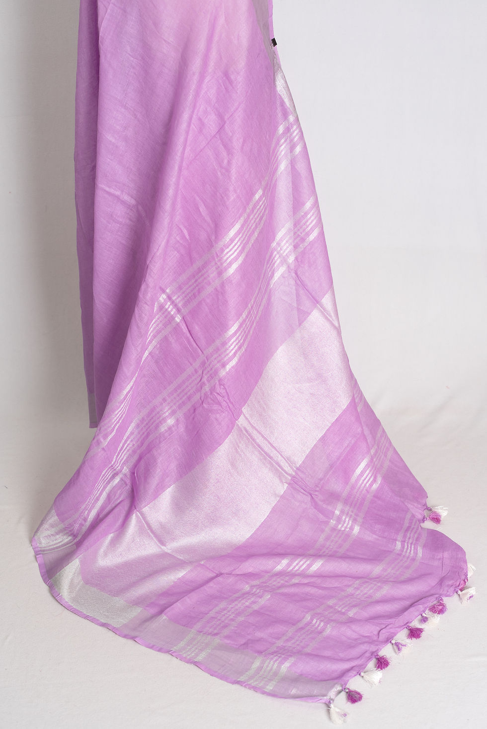 Thumbnail: Lilac pure linen saree with silver zari border draped on mannequin.
