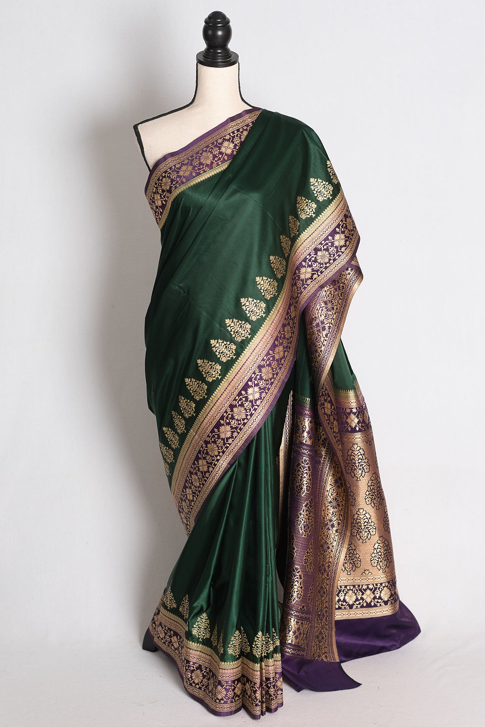 Bottle Green and Purple Semi Mashru Valkalam Banarasi Saree draped on a mannequin showcasing its rich purple contrast border.
