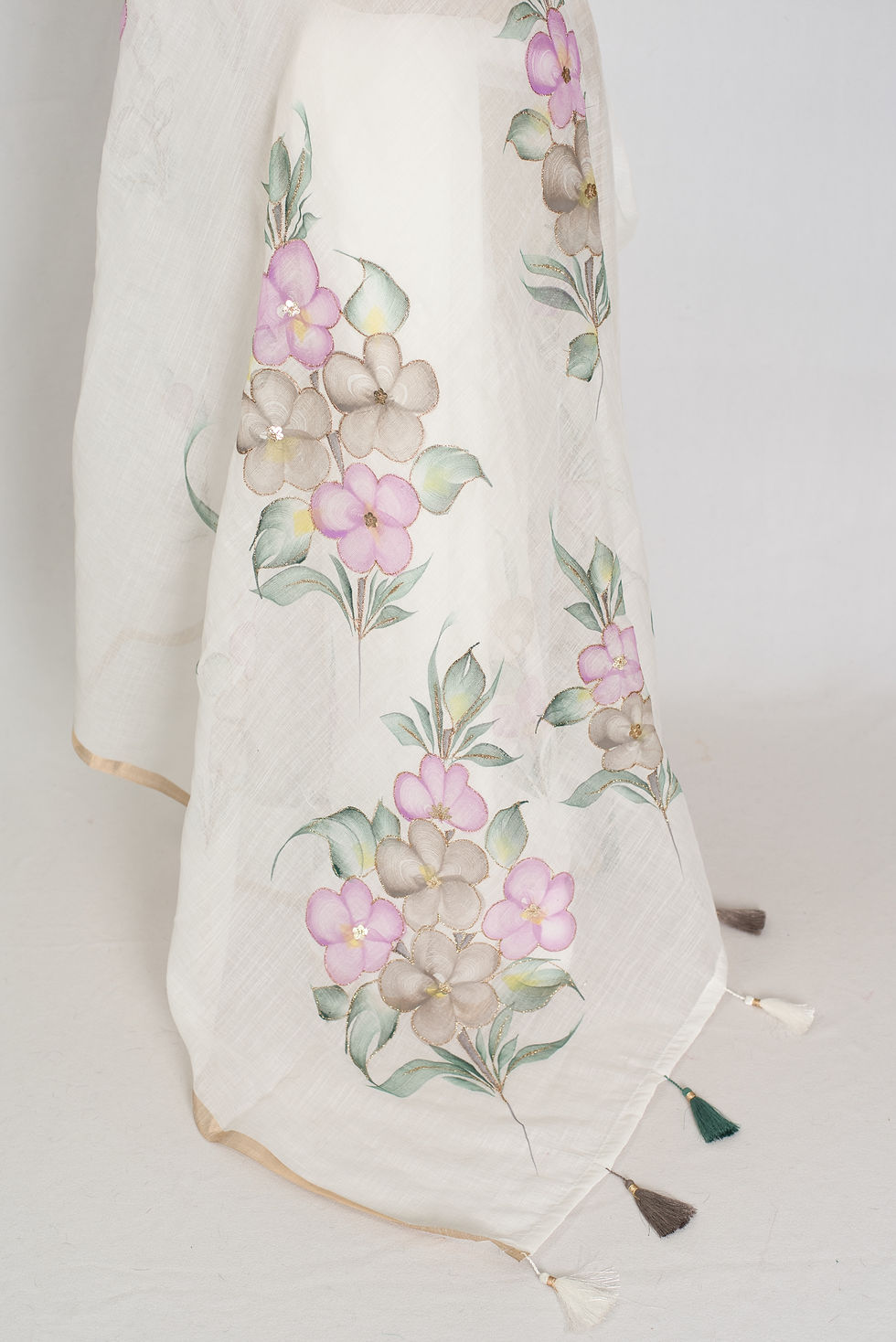 Thumbnail: Sree collection: Pristine white hand-painted cotton saree with multi-color floral designs highlighted by embroidery.