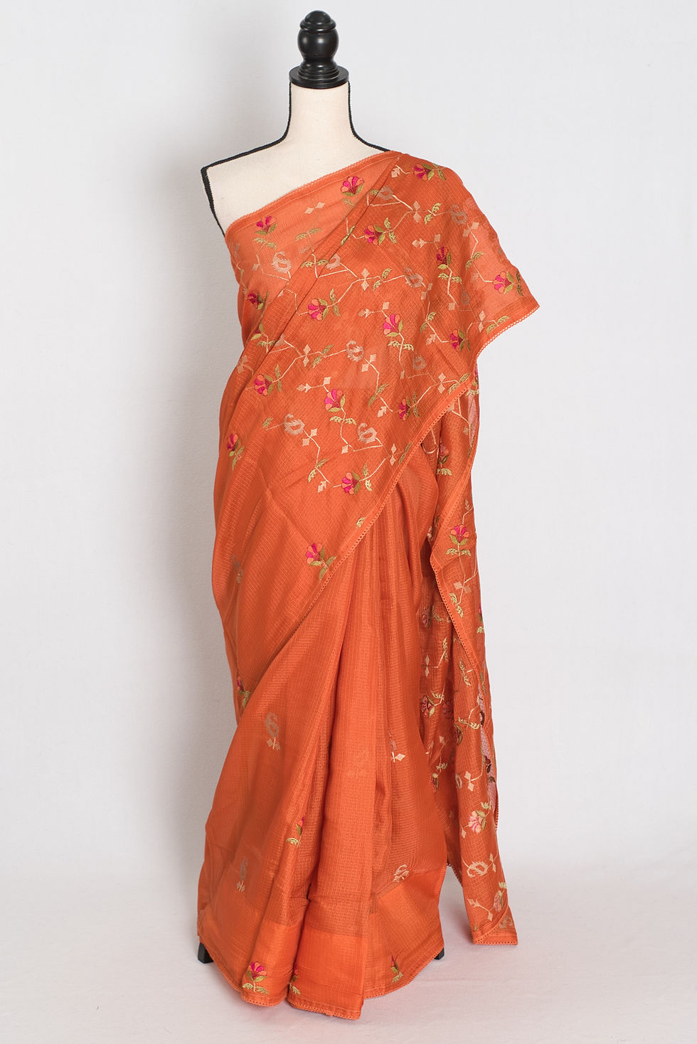 Vibrant orange blended Kota silk saree featuring a soft flowy drape and delicate floral machine embroidery.