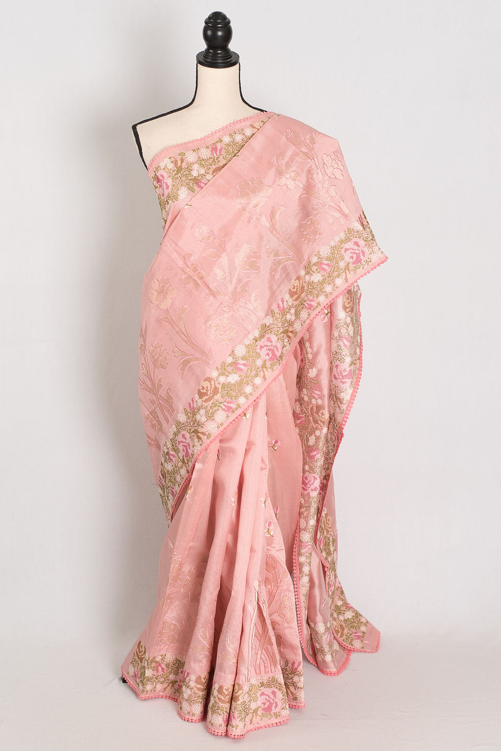 Sonia baby pink semi Tussar silk saree with floral cross stitch embroidery displayed on a mannequin.
