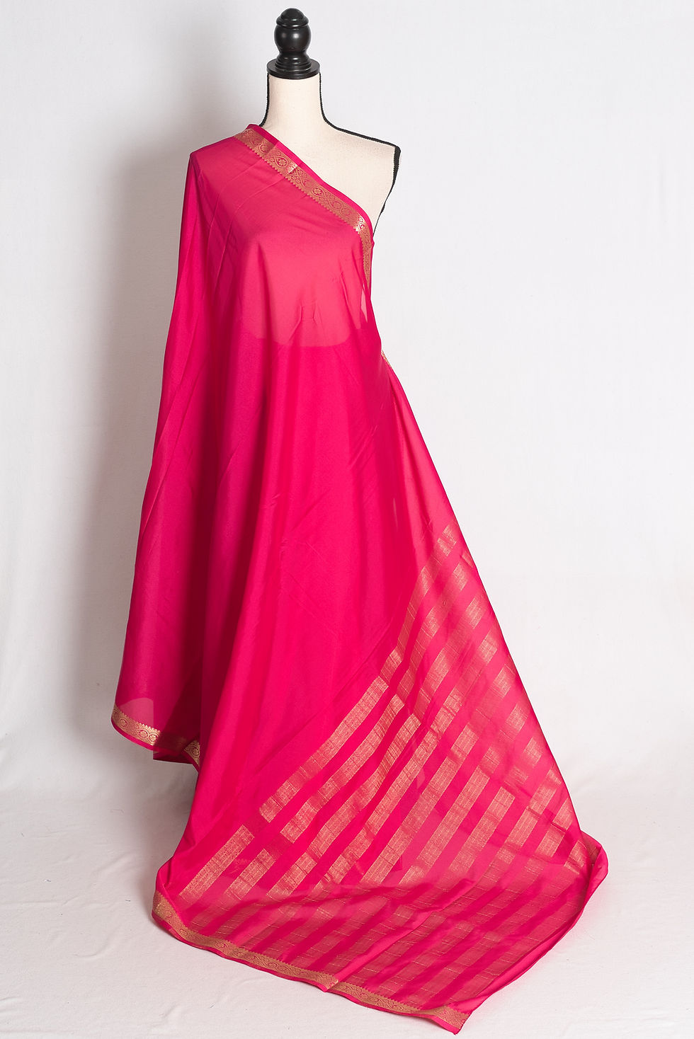 Dark Pink and Gold Semi Mysore Silk Saree draped elegantly on a mannequin showcasing its gold zari border and striped pallu.