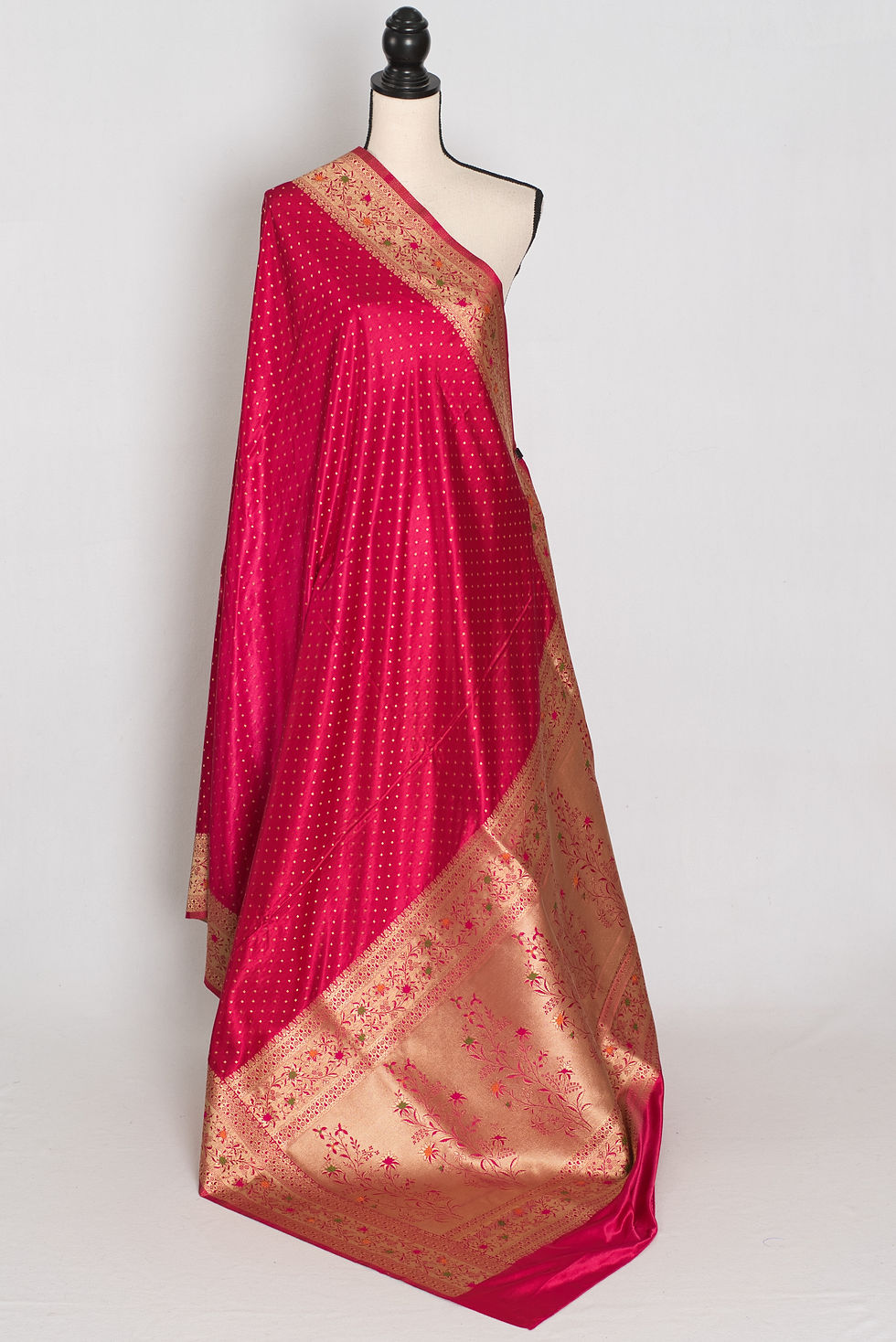 Thumbnail: Rose pink semi mashru Banarasi saree draped on a mannequin displaying its all-over gold zari butis.