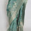 Thumbnail: Grey-green semi crepe silk Banarasi saree with silver or gold zari floral patterns (Harini Collection).