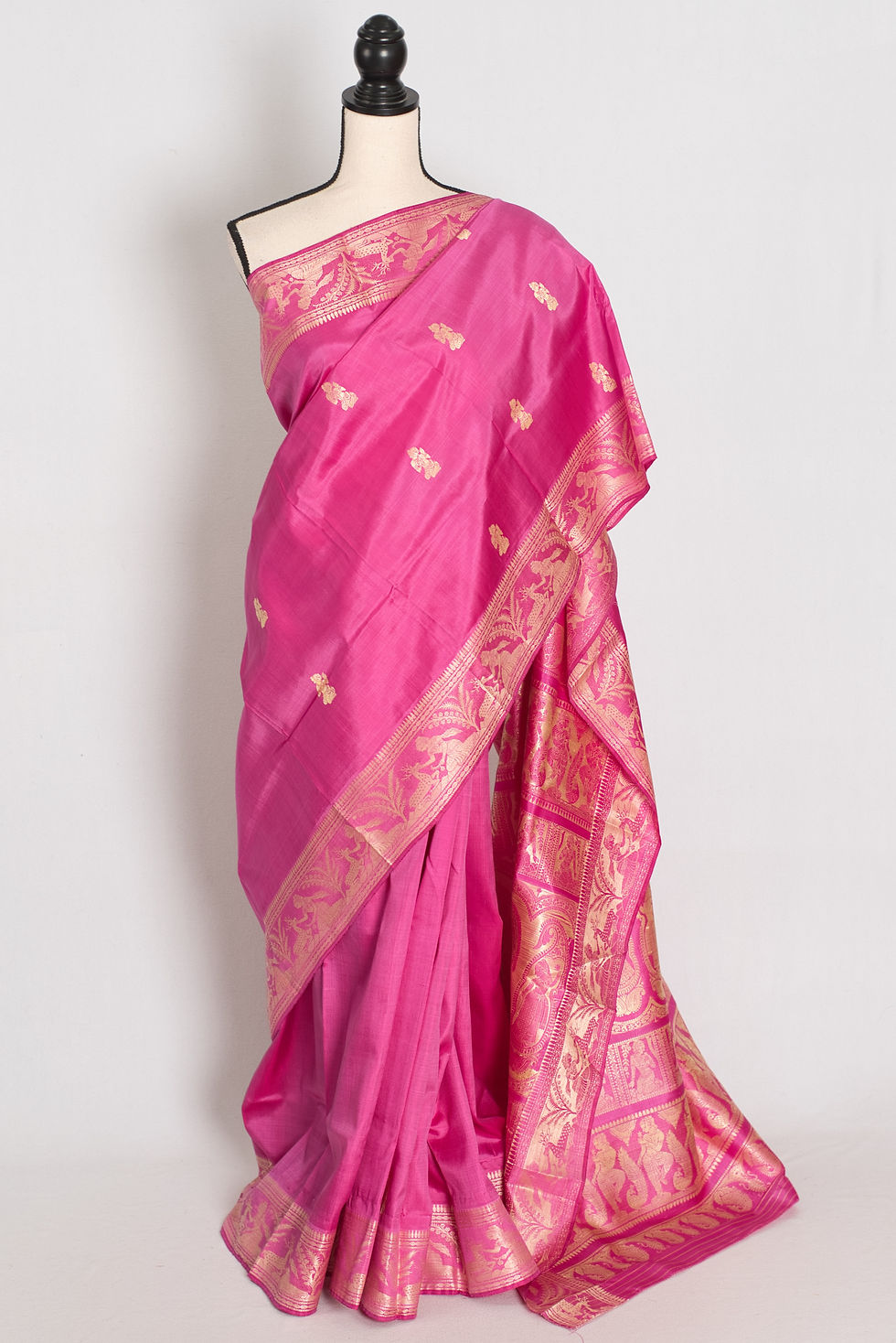 Front full-length view of the vibrant pink and cream handwoven Bishnupuri Baluchari pure silk saree draped on a mannequin.