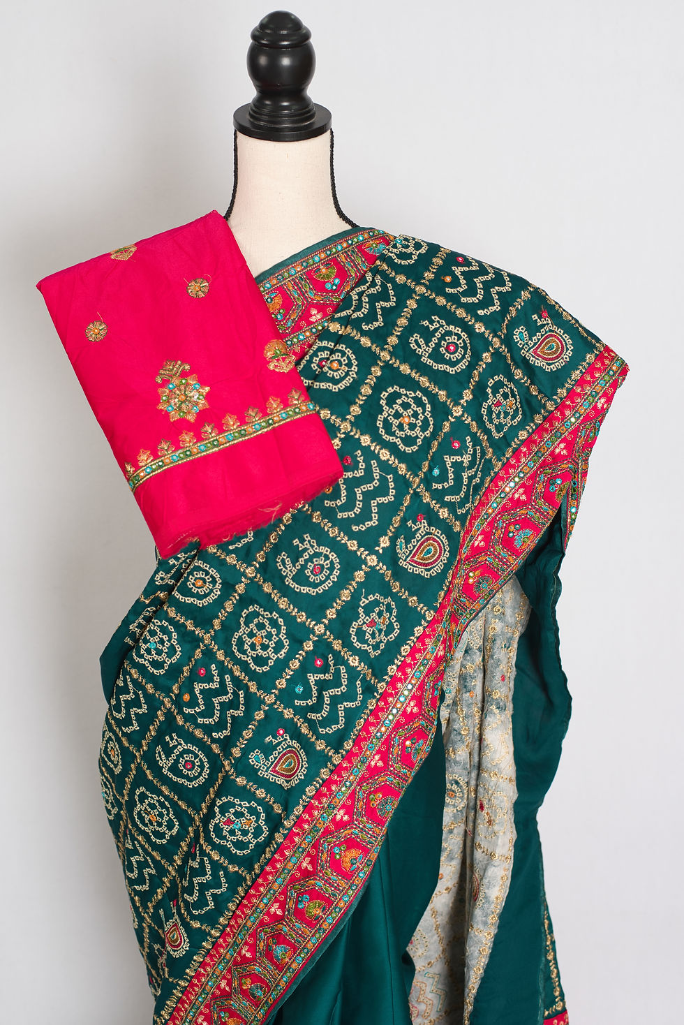 Thumbnail: dark green and hot pink semi silk Gharchola saree with heavy machine thread embroidery on a mannequin.