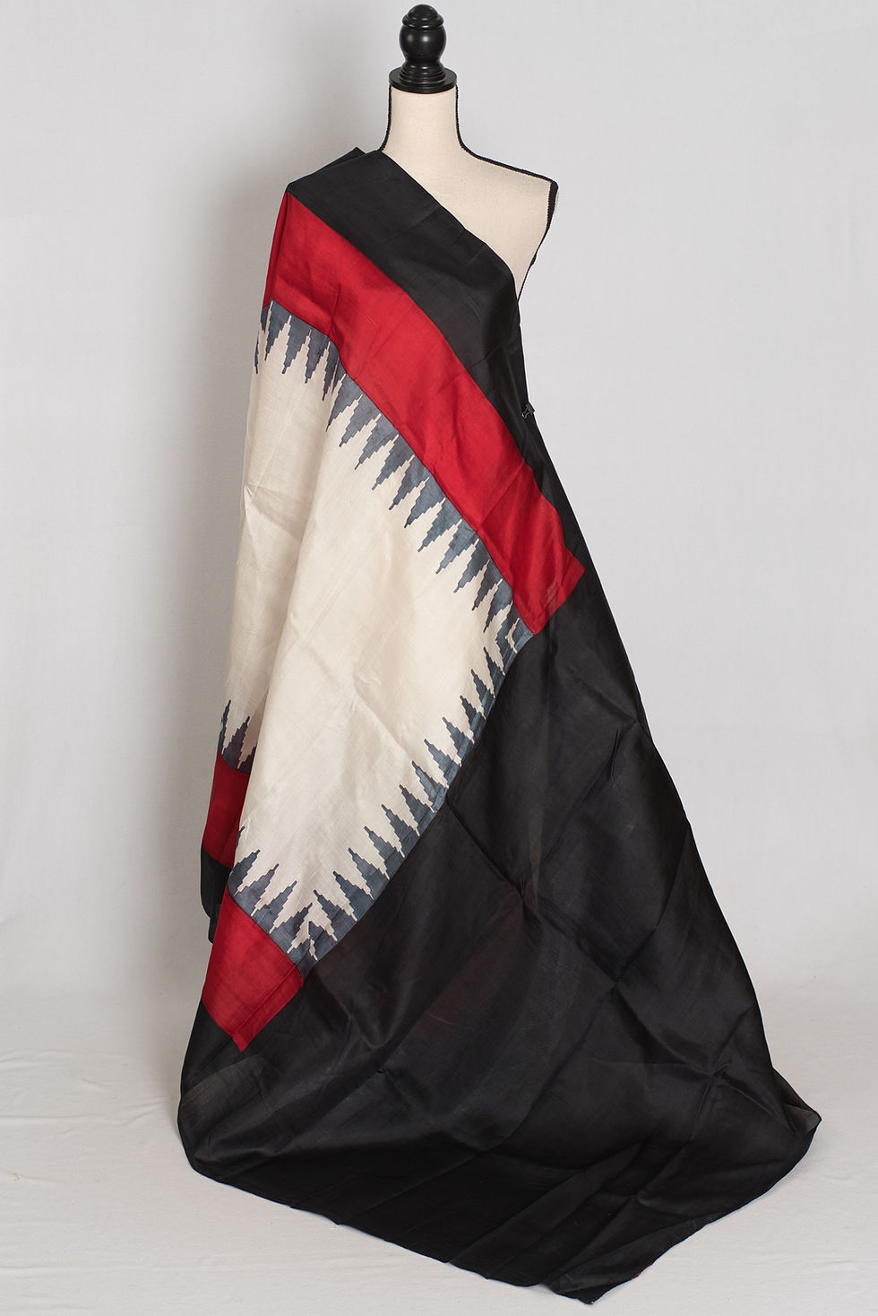 Thumbnail: Mohita white, black, and red Murshidabad silk saree with a geometric temple border design draped beautifully on a mannequin.