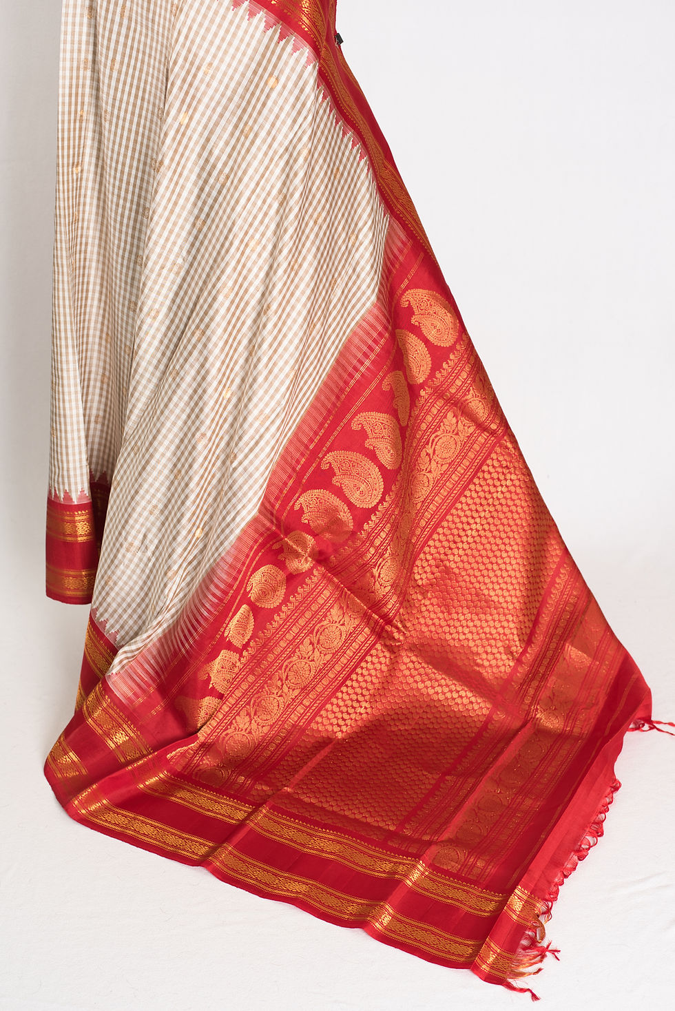 Thumbnail: Mira white and brown micro-check Gadwal silk saree with a rich red and gold zari border.