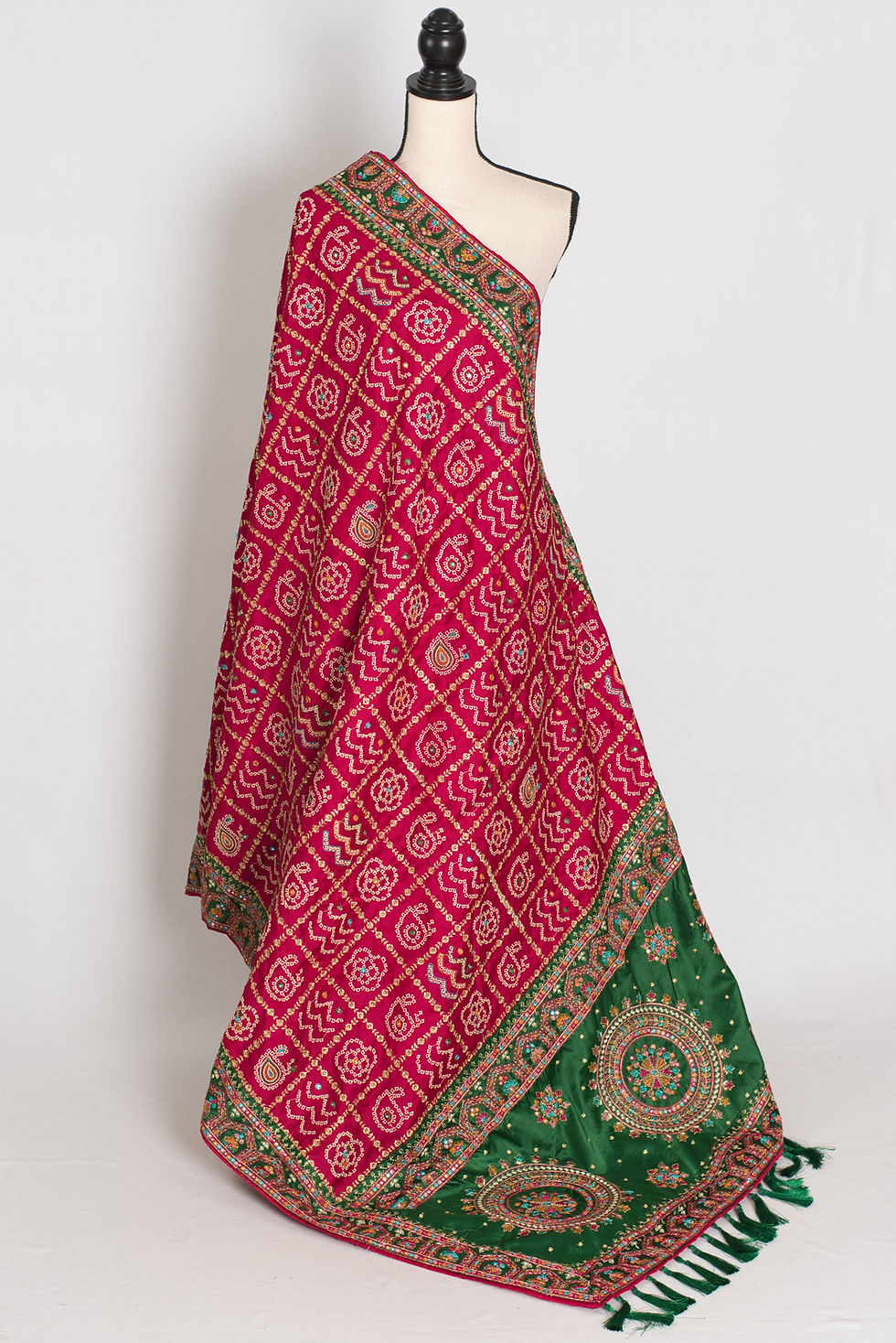 Front full-length view of the purple and green traditional Gujarati style Gharchola saree draped on a mannequin.