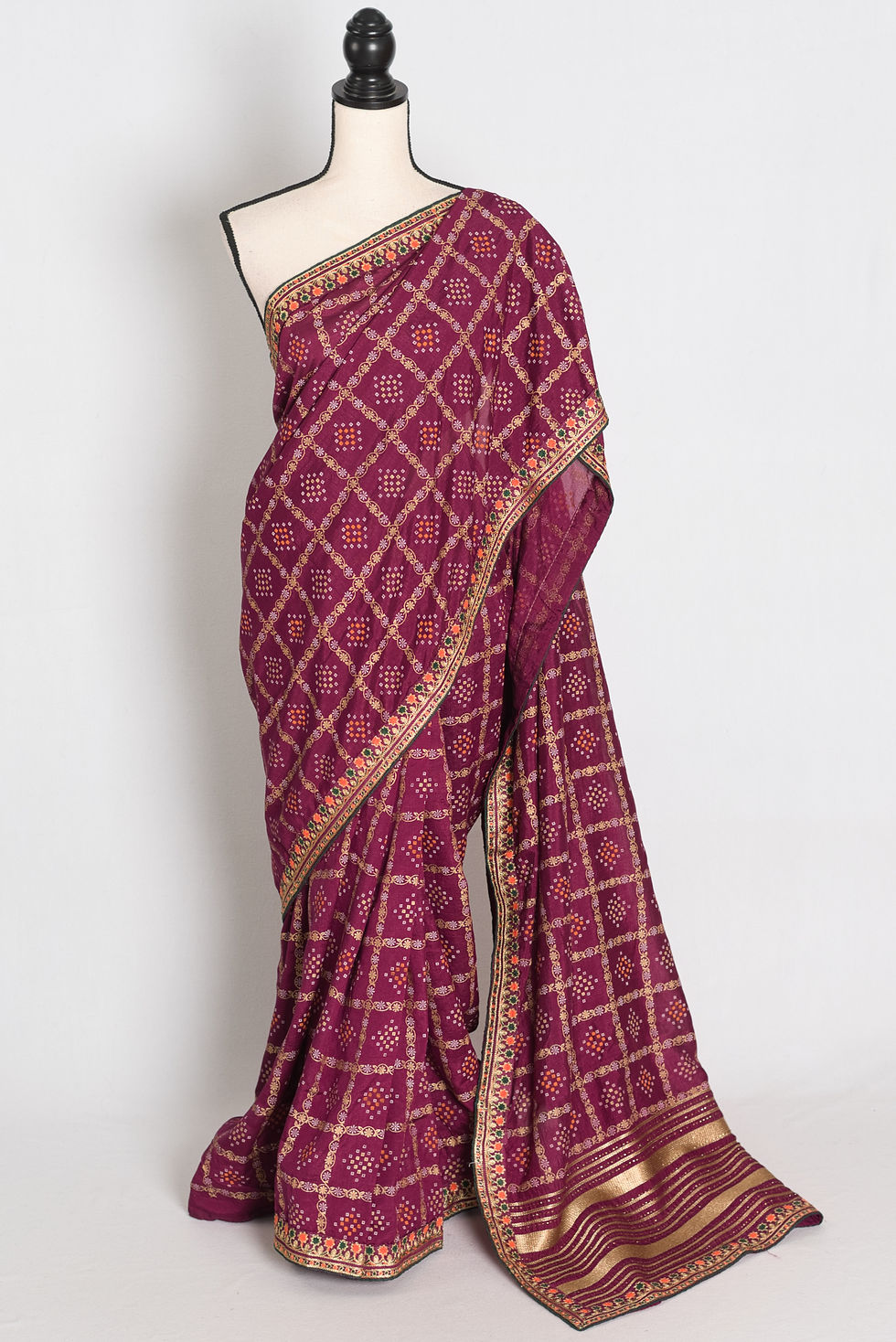Purple Gharchola gold printed saree with stitched embroidery border draped on a mannequin, showcasing the full length.