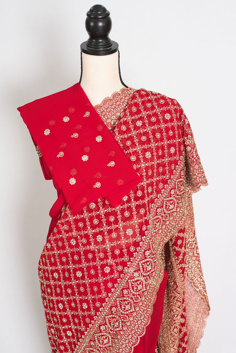 Thumbnail: Red and gold georgette bridal saree on a mannequin showing golden thread embroidery grid jaal, and heavy scalloped borders.