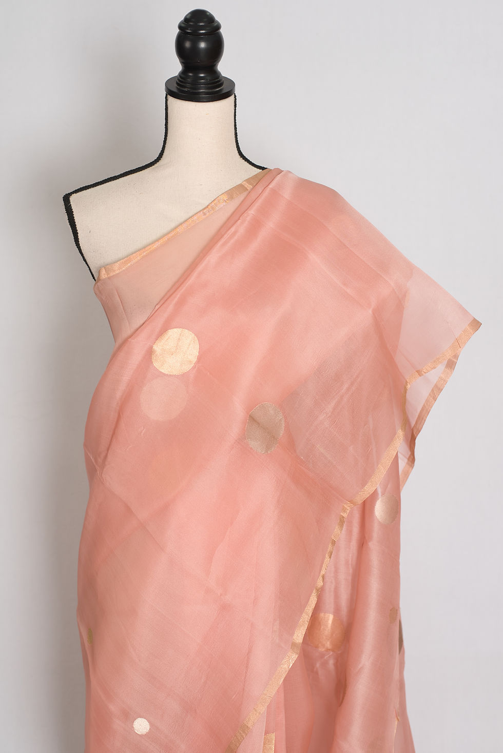 Thumbnail: Peachy pink handwoven Kora Banarasi silk saree featuring large gold zari polka dots and minimal gold border.