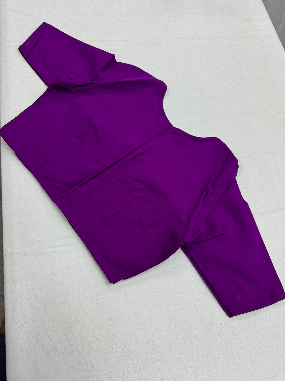Thumbnail: Full back view of the tailor-made purple saree blouse showing the high covered back design and elbow-length sleeves.