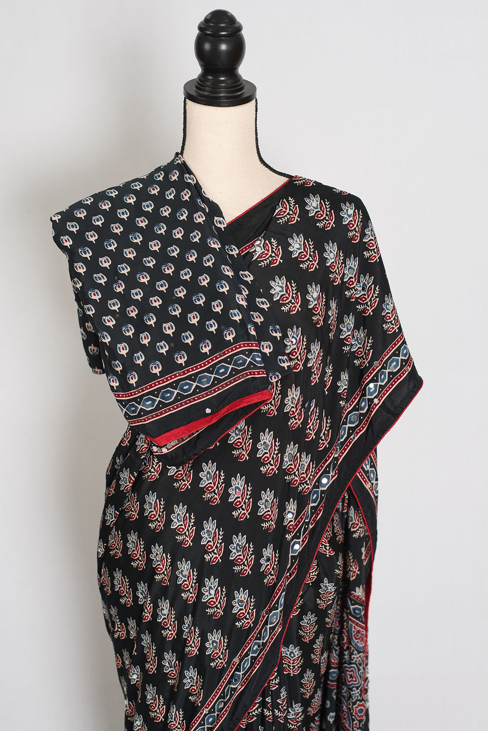 Thumbnail: Black semi modal silk partywear saree draped on a mannequin, showcasing mirror work.